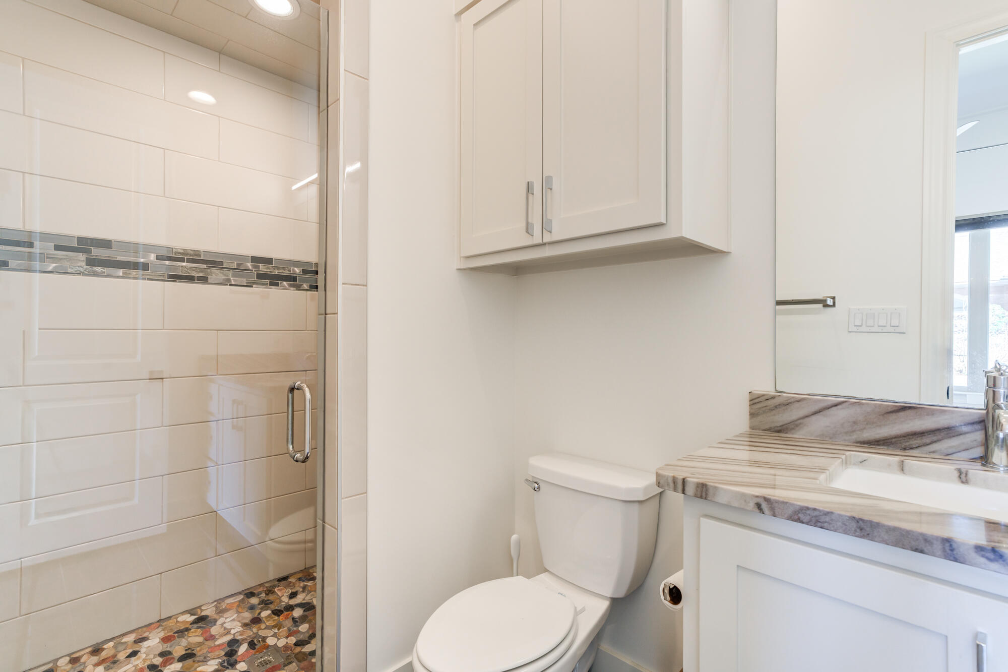 4813 5th Street Lubbock, TX 79416 - Photo 40 of 62 a bathroom with a granite countertop sink a toilet and shower