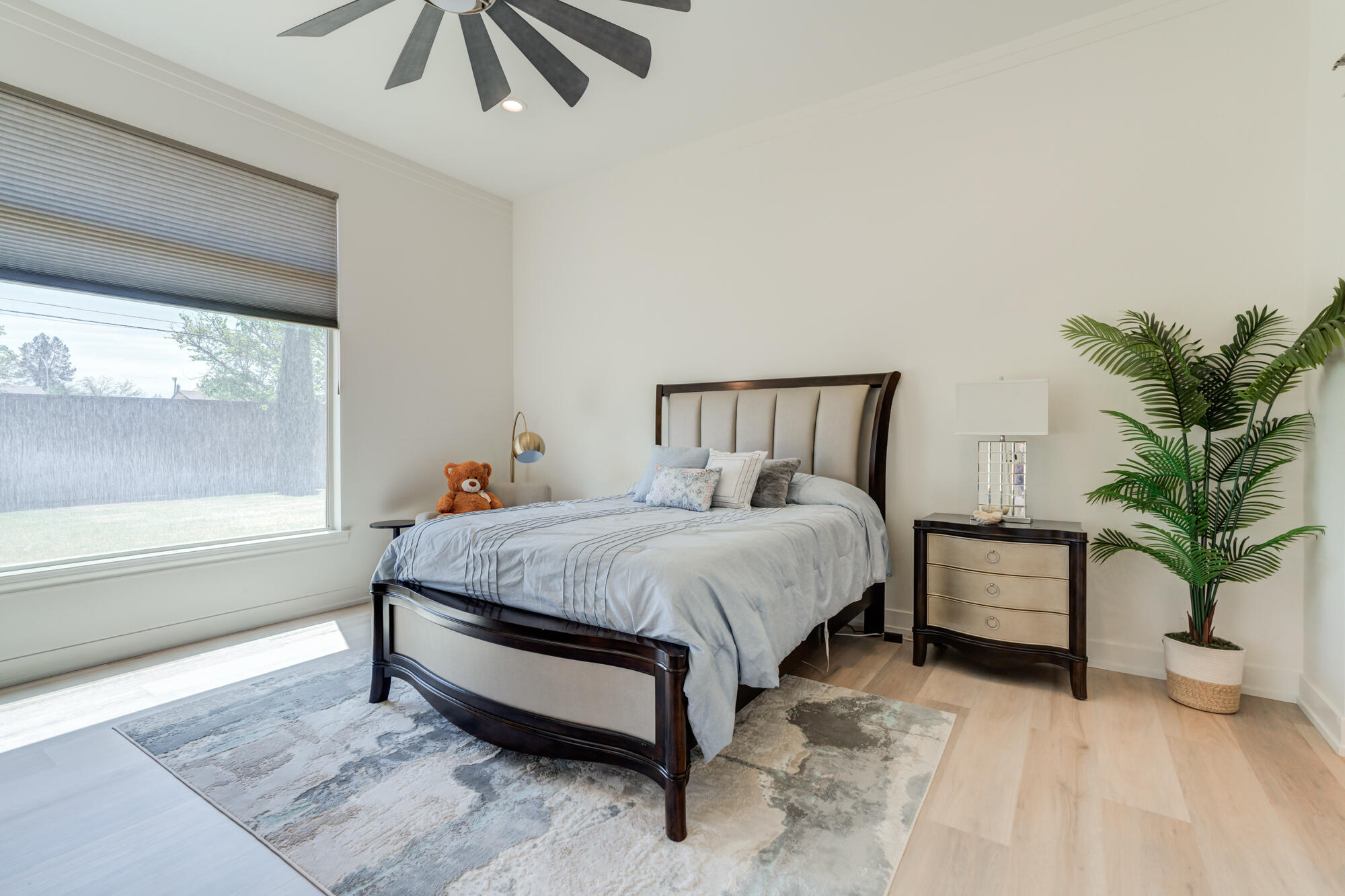 4813 5th Street Lubbock, TX 79416 - Photo 4 of 62 a spacious bedroom with a bed and a potted plant
