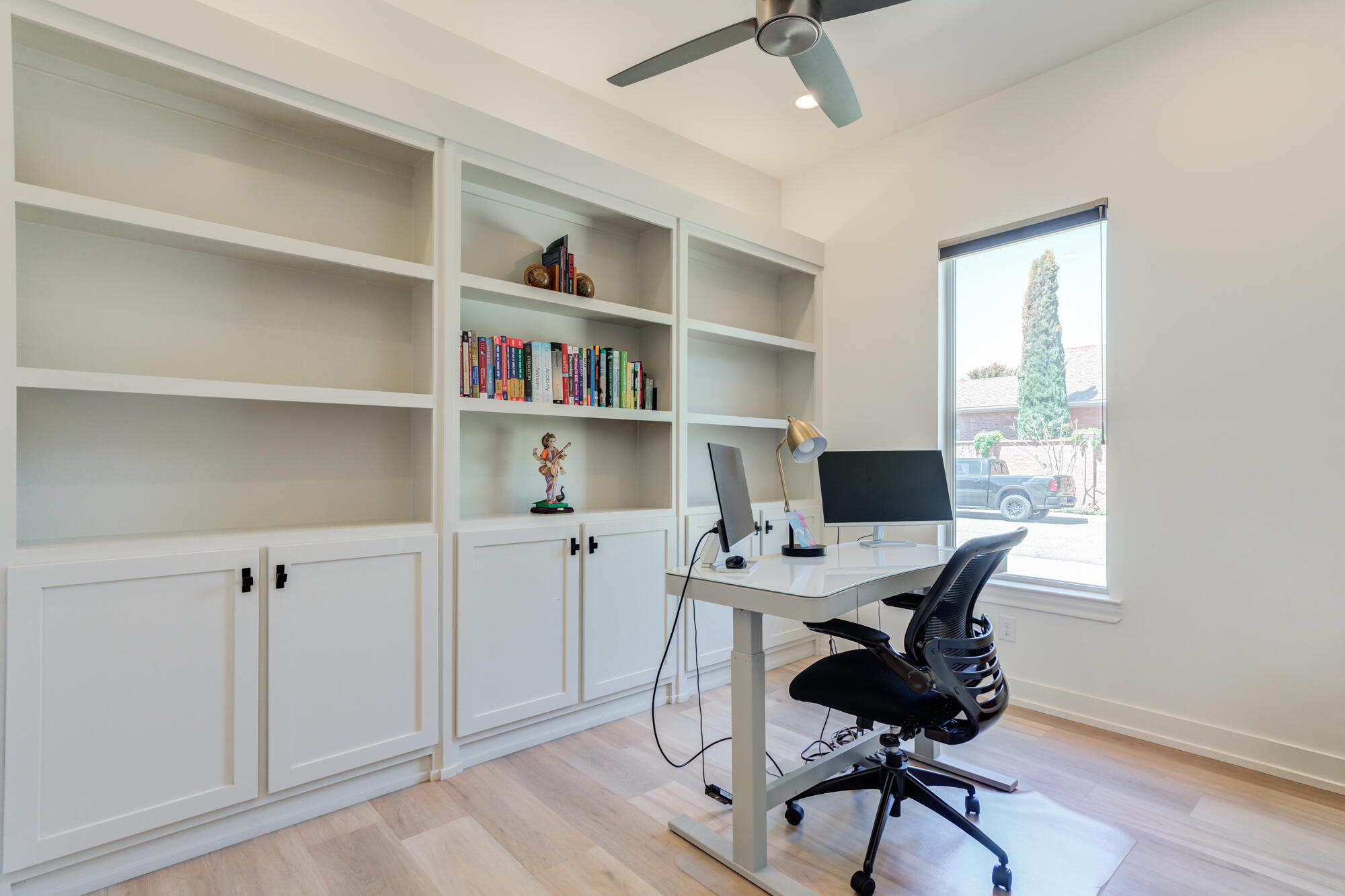 4813 5th Street Lubbock, TX 79416 - Photo 41 of 62 a view of a workspace with furniture and a window