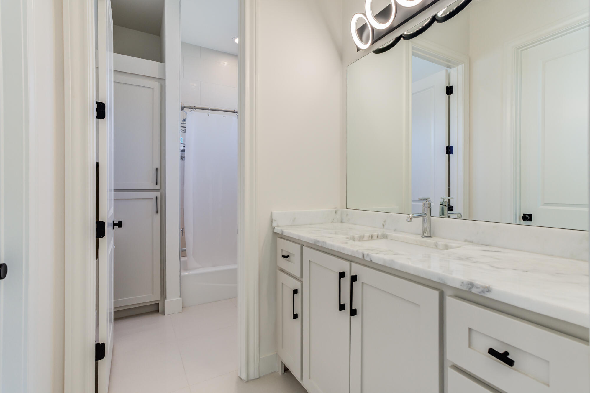 4813 5th Street Lubbock, TX 79416 - Photo 44 of 62 a bathroom with a granite countertop sink and a mirror