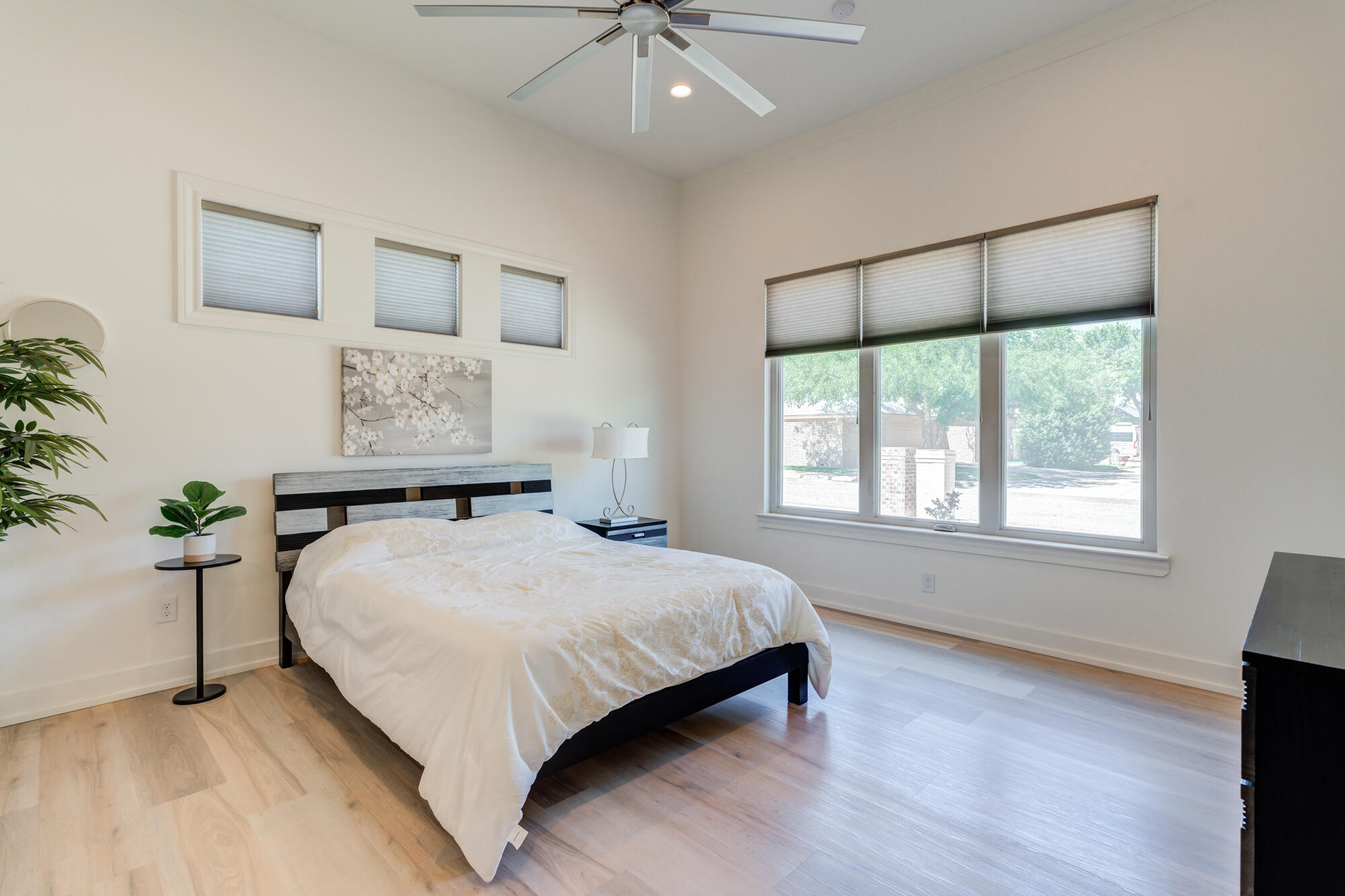 4813 5th Street Lubbock, TX 79416 - Photo 46 of 62 a bedroom with a large bed and a chandelier