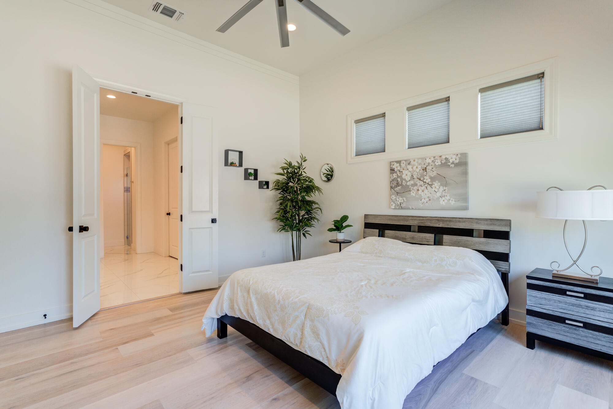 4813 5th Street Lubbock, TX 79416 - Photo 47 of 62 a bedroom with a bed and a potted plant