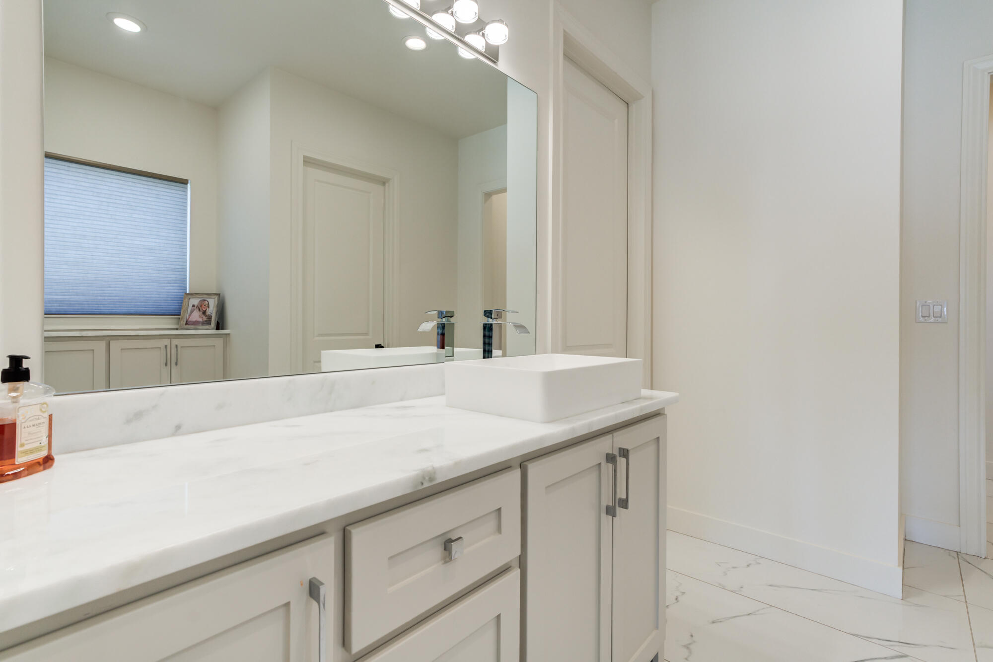 4813 5th Street Lubbock, TX 79416 - Photo 49 of 62 a bathroom with a sink and a mirror
