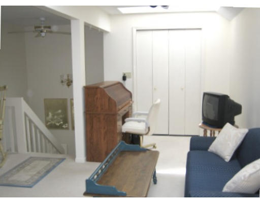 103 D Ridgefield Circle, Unit D Clinton, MA 01510 - Photo 11 of 12 a living room with furniture and a couch