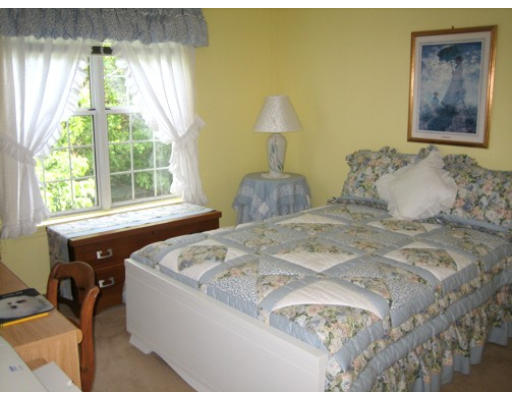 103 D Ridgefield Circle, Unit D Clinton, MA 01510 - Photo 12 of 12 a bedroom with a bed and a window