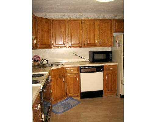 103 D Ridgefield Circle, Unit D Clinton, MA 01510 - Photo 2 of 12 a kitchen with a sink cabinets and appliances