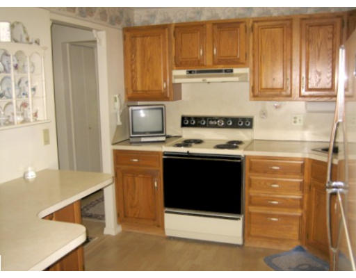 103 D Ridgefield Circle, Unit D Clinton, MA 01510 - Photo 3 of 12 a kitchen with stainless steel appliances granite countertop a stove and a refrigerator