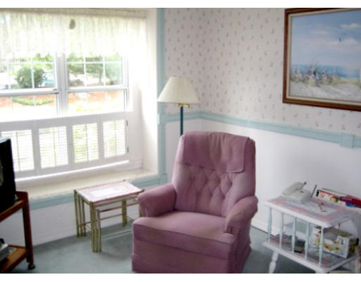 103 D Ridgefield Circle, Unit D Clinton, MA 01510 - Photo 7 of 12 a living room with furniture and a window