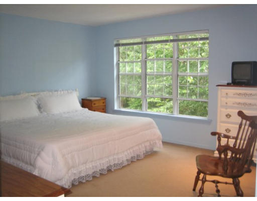 103 D Ridgefield Circle, Unit D Clinton, MA 01510 - Photo 9 of 12 a bedroom with a bed and a chair