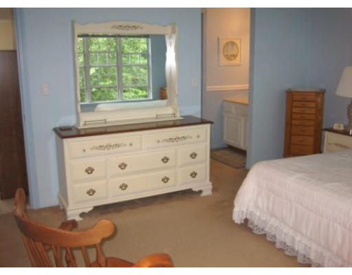 103 D Ridgefield Circle, Unit D Clinton, MA 01510 - Photo 10 of 12 a bedroom with a bed and a dresser