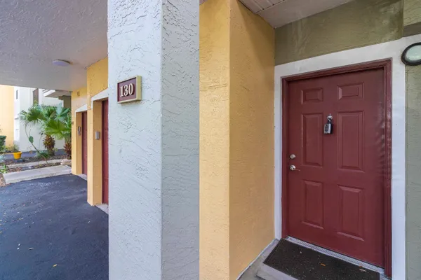 a kitchen with granite countertop a stove a sink and a refrigerator