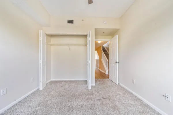 a living room with a large window and a chandelier