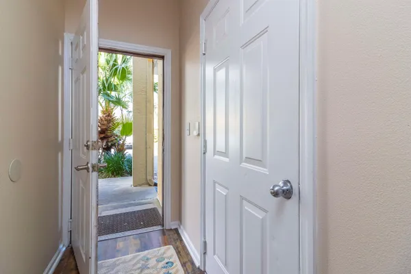 a view of a kitchen with kitchen island a sink wooden floor and a refrigerator