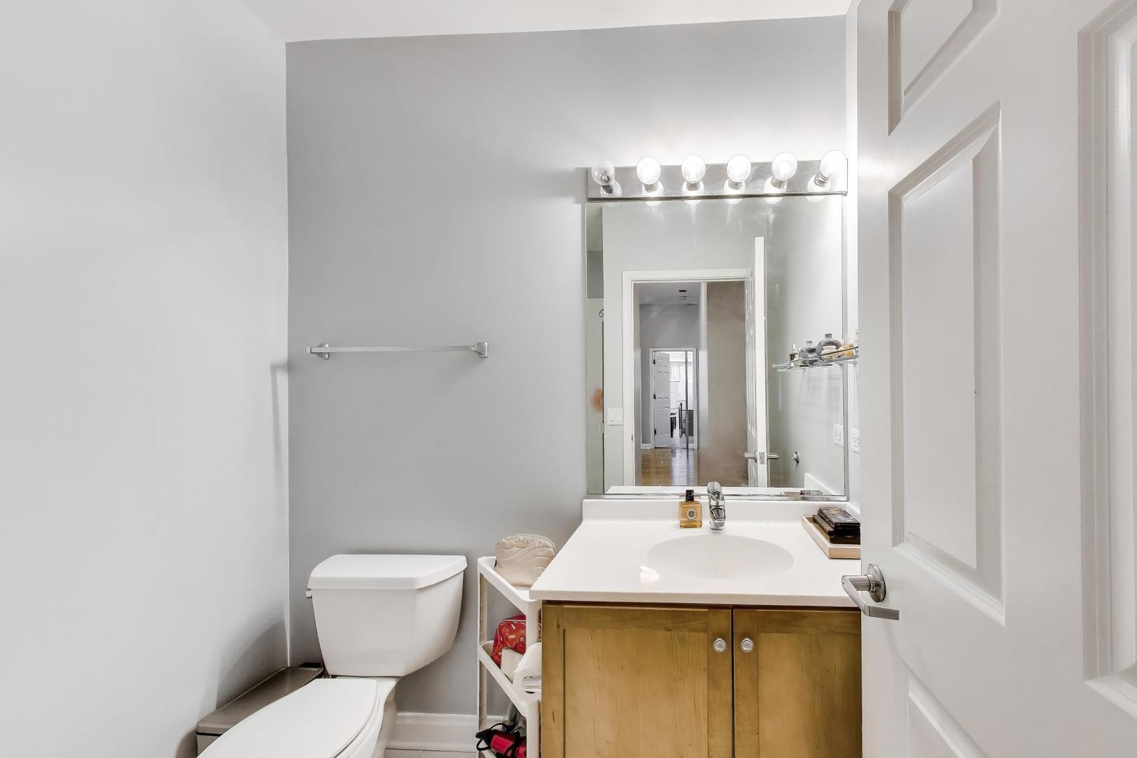8 West Monroe Street, Unit 704 Chicago, IL 60603 - Photo 16 of 35 a bathroom with a sink and a mirror