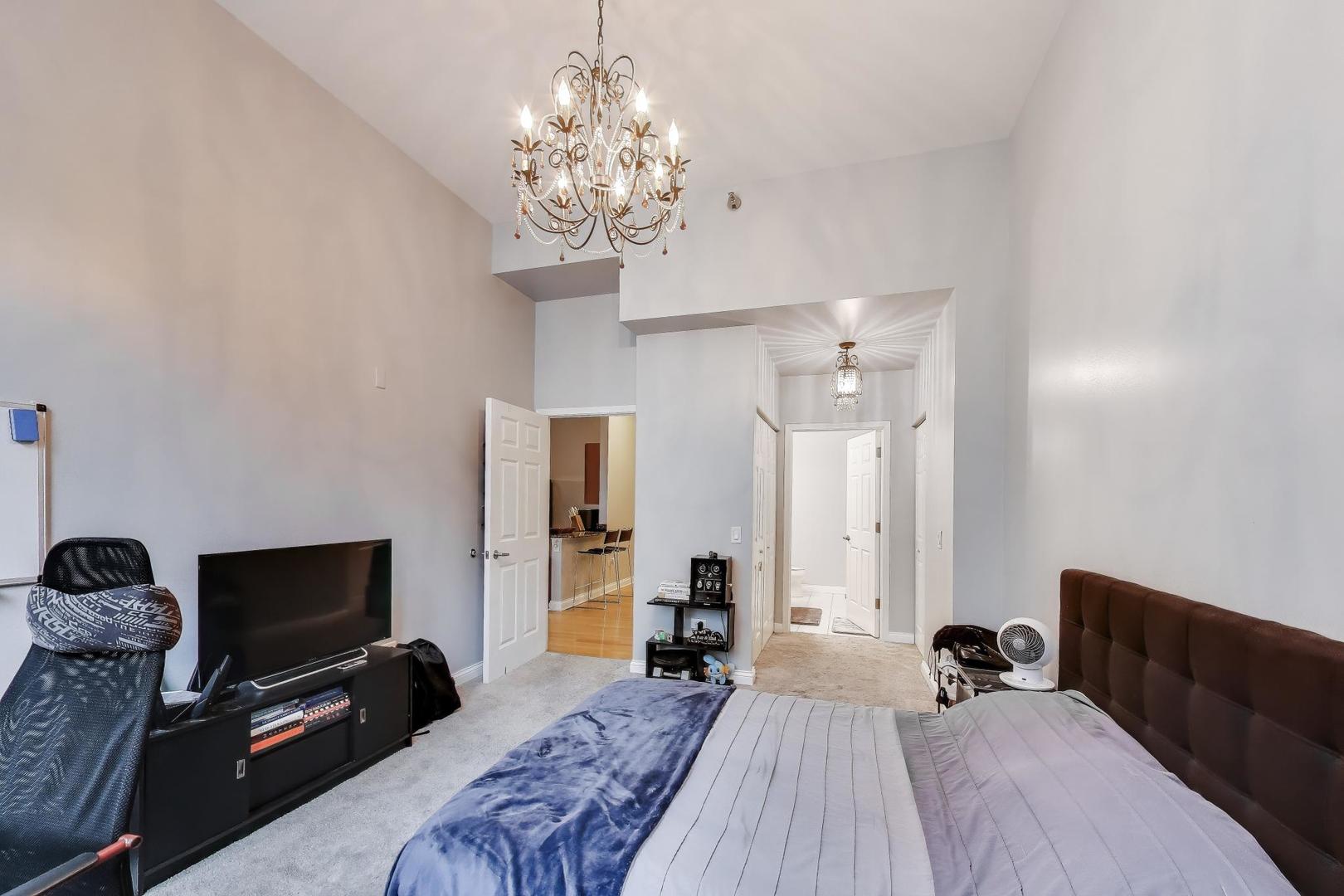 8 West Monroe Street, Unit 704 Chicago, IL 60603 - Photo 19 of 35 a bedroom with bed tv and window