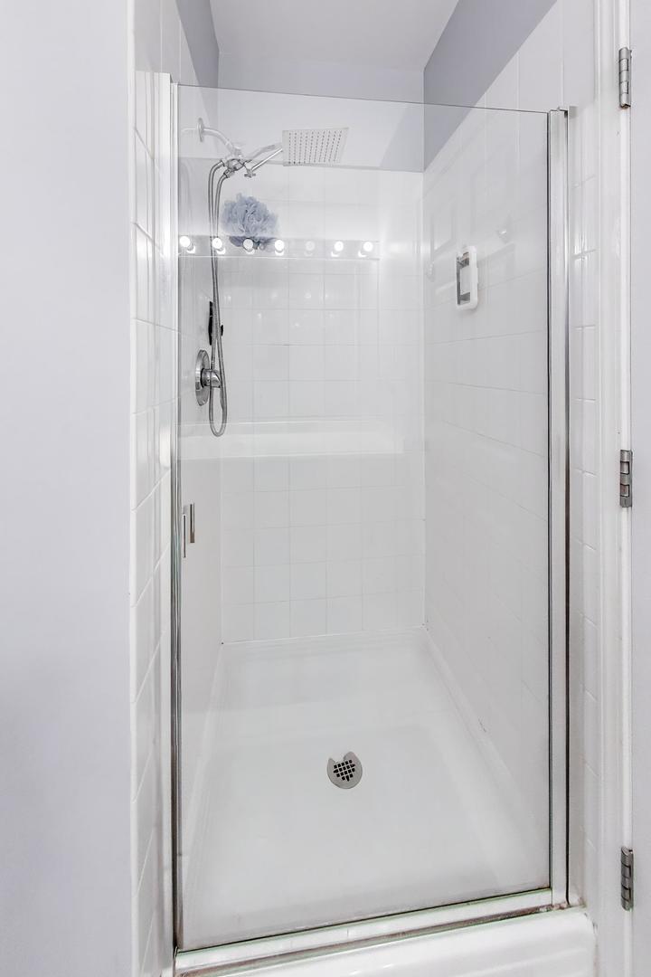 8 West Monroe Street, Unit 704 Chicago, IL 60603 - Photo 23 of 35 a bathroom with a glass shower door