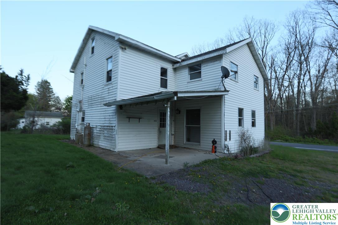 5444 Quakake Road Weatherly, PA 18255 - Photo 8 of 21 A classic two-story residence with white siding and a functional covered patio.
