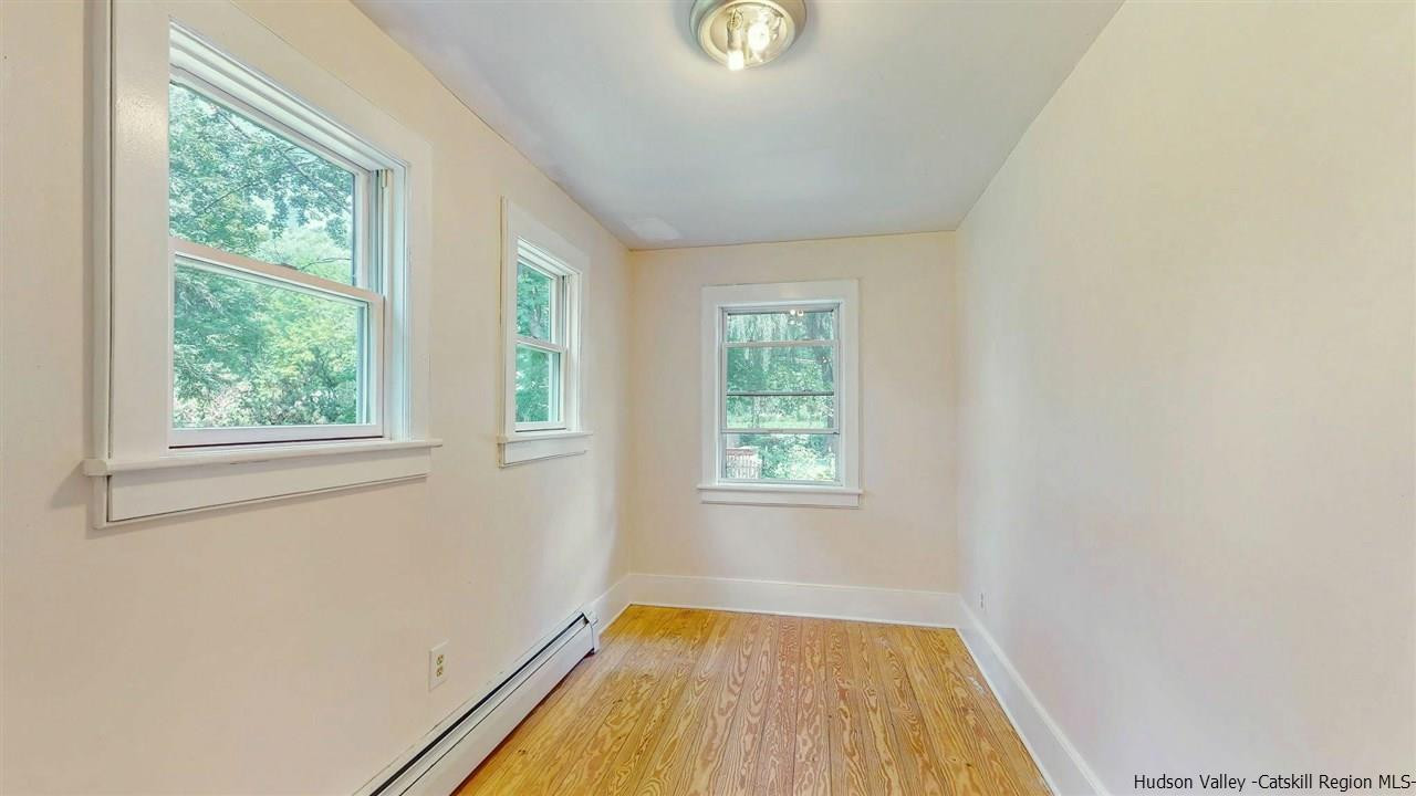 322 Main Street Rosendale, NY 12472 - Photo 15 of 35 an empty room with wooden floor and windows