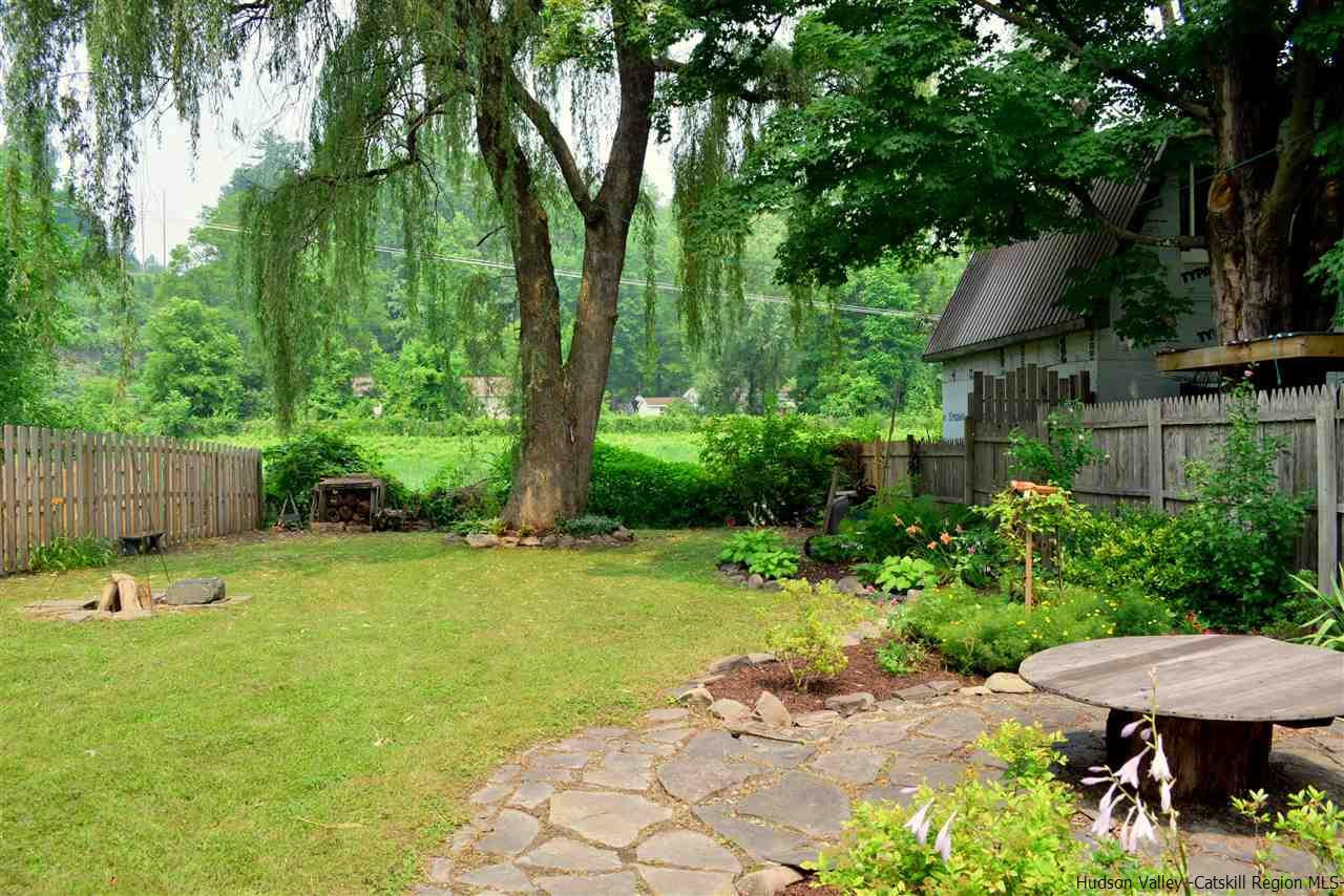 322 Main Street Rosendale, NY 12472 - Photo 18 of 35 a backyard of a house with a garden and plants