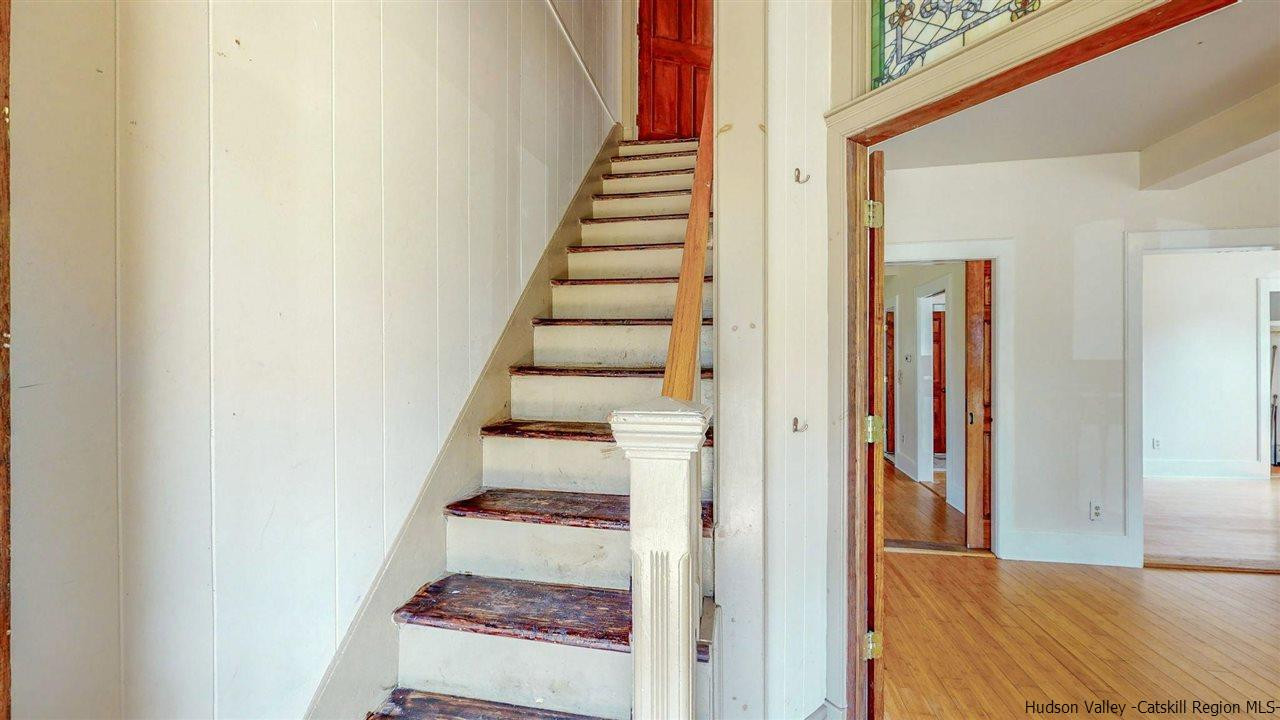 322 Main Street Rosendale, NY 12472 - Photo 19 of 35 a view of a hallway with front door wooden floor and stairs