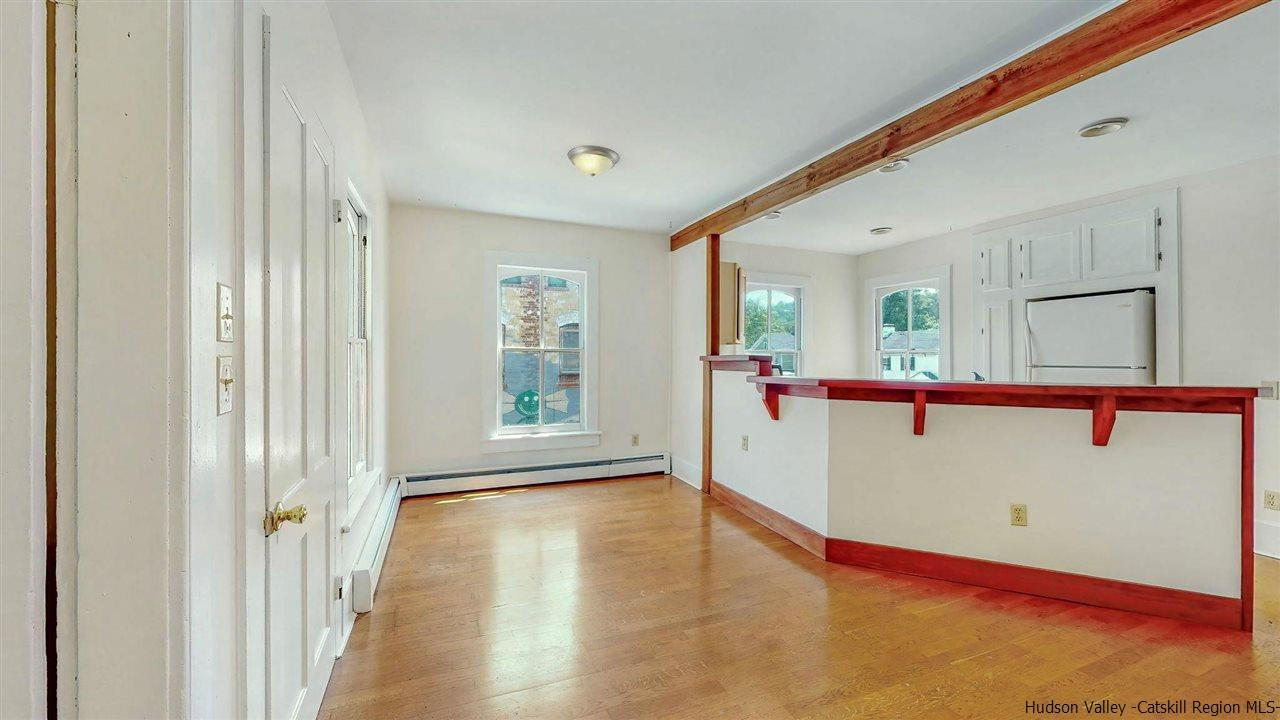 322 Main Street Rosendale, NY 12472 - Photo 22 of 35 a view of a hallway with wooden floor and a living room