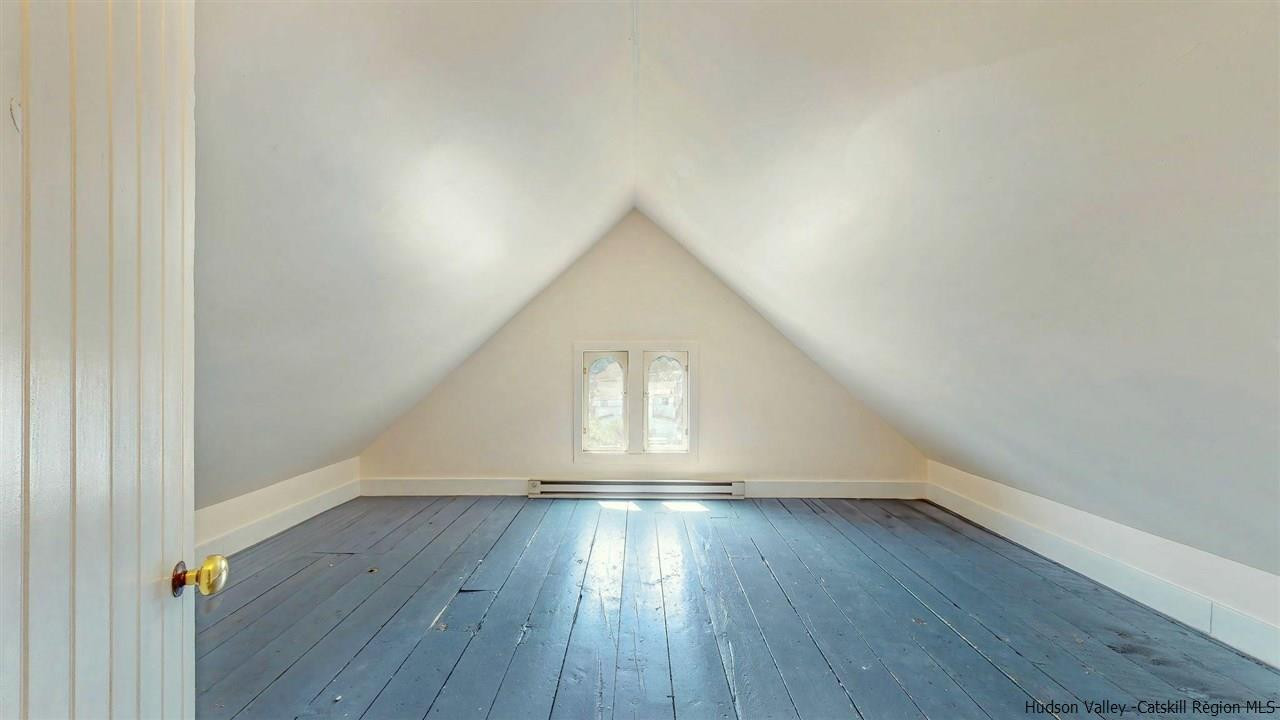 322 Main Street Rosendale, NY 12472 - Photo 32 of 35 an empty room with wooden floor and windows