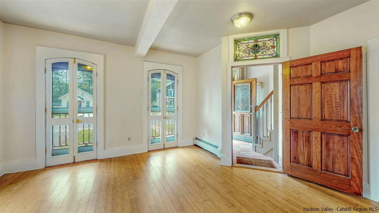 322 Main Street Rosendale, NY 12472 - Photo 7 of 35 an empty room with wooden floor and windows