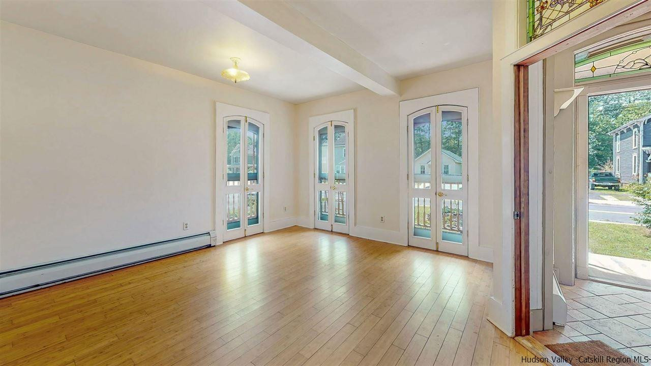 322 Main Street Rosendale, NY 12472 - Photo 8 of 35 a view of an empty room with wooden floor and a window