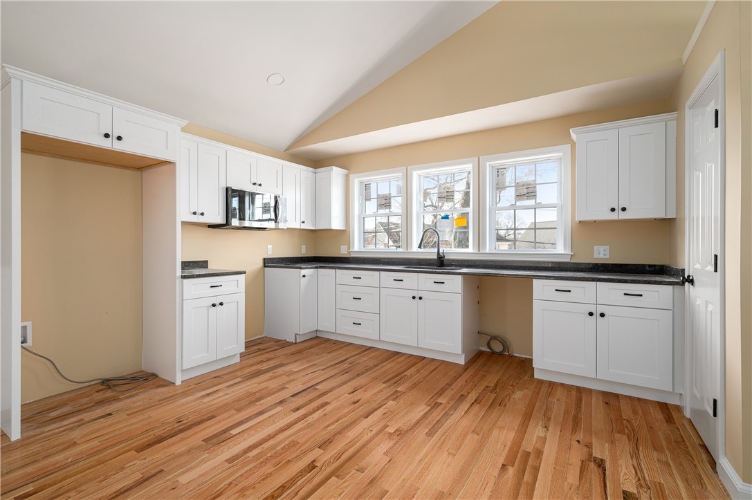 23 Henry Street Woonsocket, RI 02895 - Photo 5 of 33 Large kitchen with granite counters and plenty of storage space. Pantry closet on right.