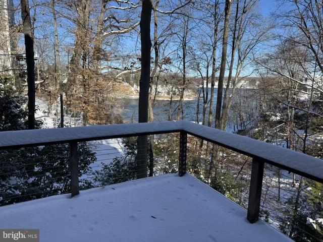 a view of a livingroom with furniture and a large window