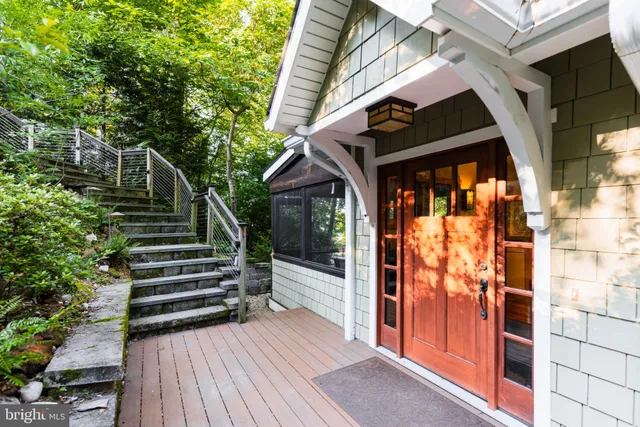 a wooden talbe and chairs sitting in the middle of a backyard