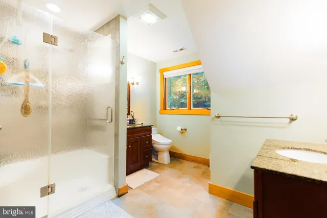 a bedroom with two beds and a window