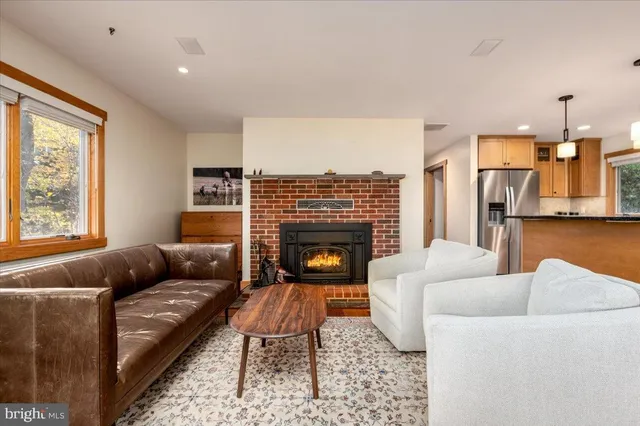 a living room with furniture and a fireplace