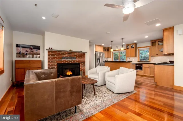 a kitchen with stainless steel appliances granite countertop a sink a stove and a refrigerator