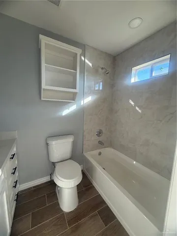 a bathroom with a toilet and a bathtub