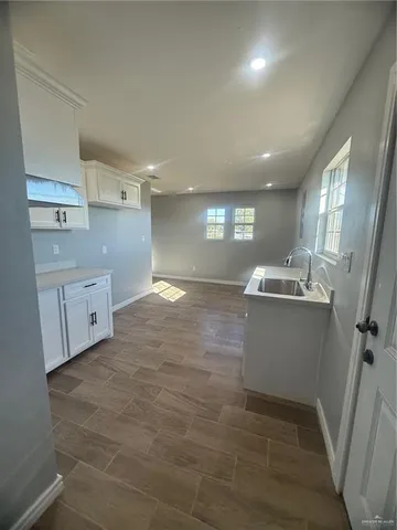a view of a kitchen with white cabinets