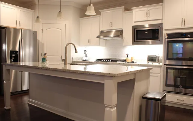 a kitchen with stainless steel appliances a sink a stove and a refrigerator