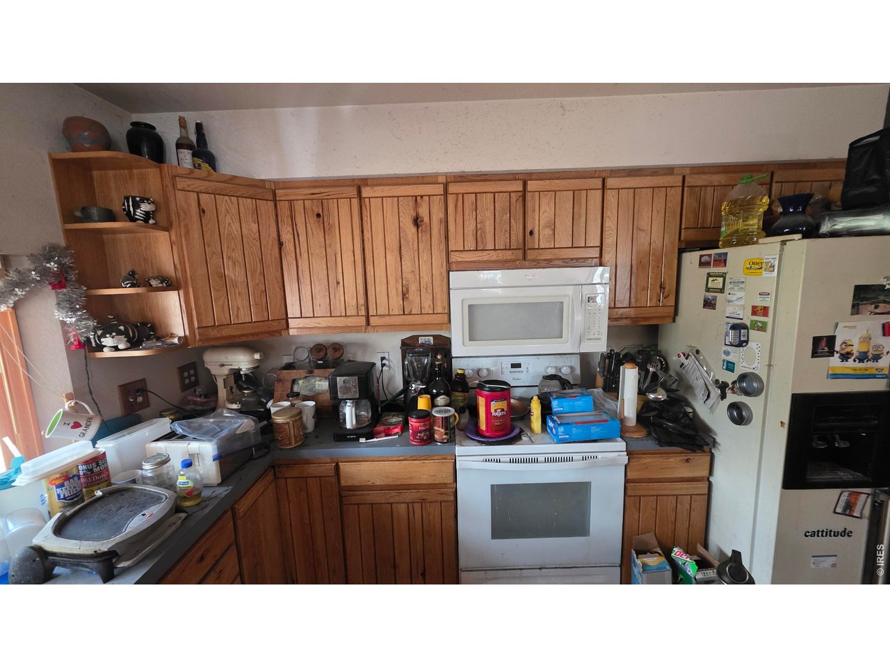 226 Pinon Way Nederland, CO 80466 - Photo 4 of 10 a kitchen with a refrigerator and a stove top oven