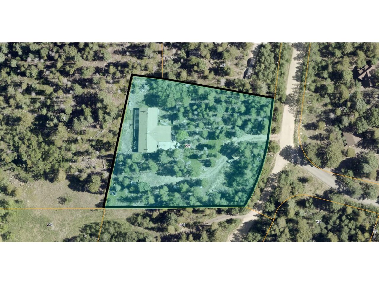 226 Pinon Way Nederland, CO 80466 - Photo 10 of 10 a black and white photo of a green field