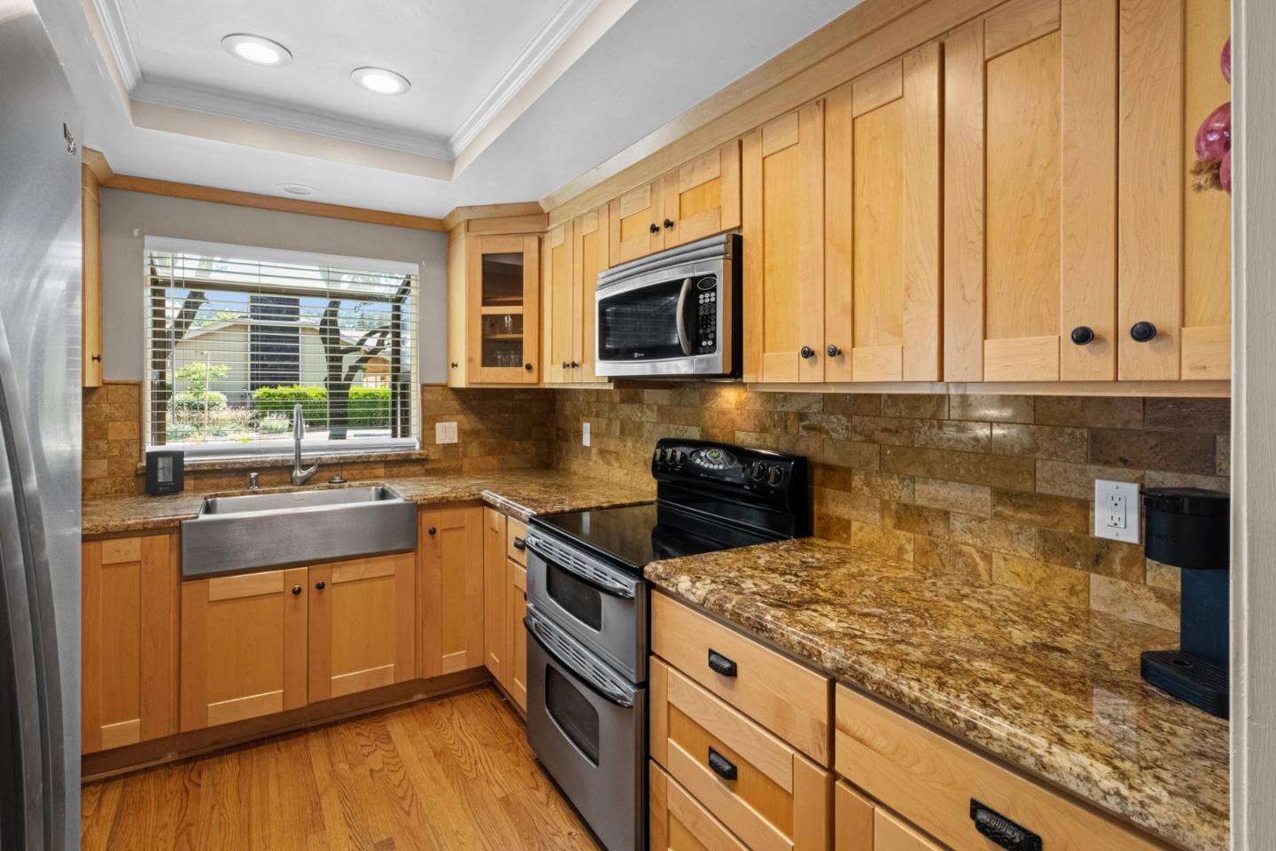 2137 Darnis Circle Morgan Hill, CA 95037 - Photo 10 of 66 a kitchen with granite countertop wooden cabinets a stove a sink and a window