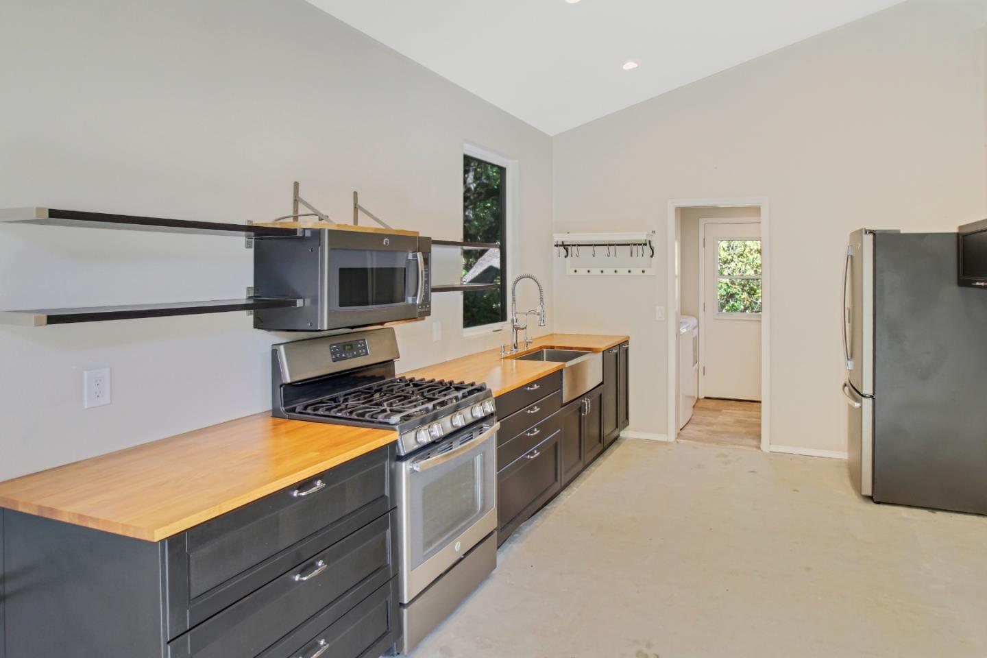 223 Rapley Ranch Road Redwood City, CA 94062 - Photo 22 of 42 a kitchen with stainless steel appliances granite countertop a refrigerator and a stove