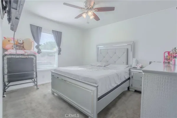 a spacious bedroom with a bed and a chandelier