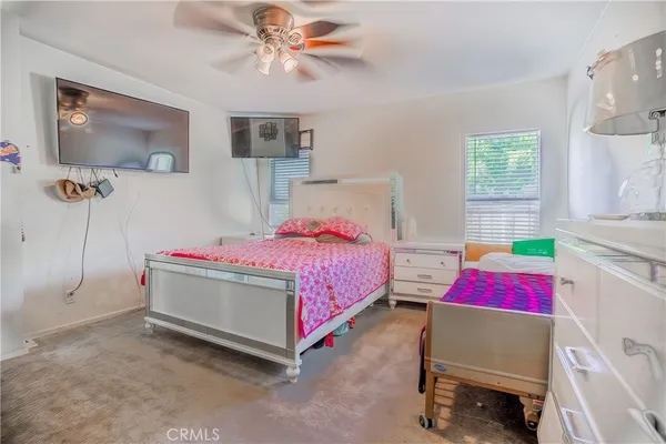 a bedroom with a bed and dresser