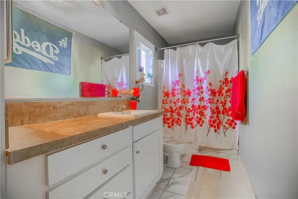 a view of a kitchen with an empty room and painted walls