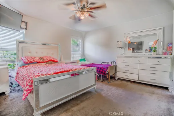a bedroom with a bed and a dresser in it