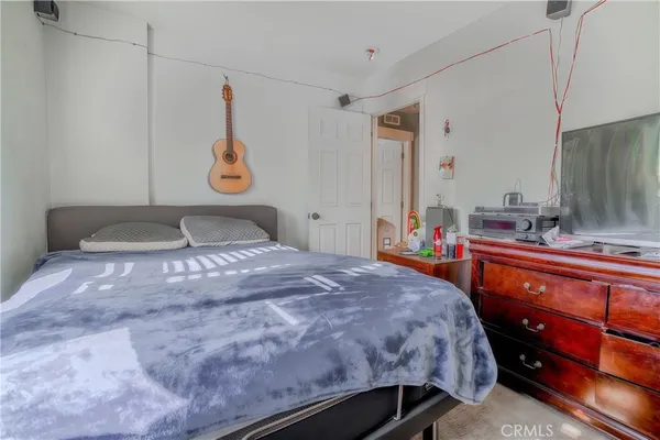 a bedroom with a bed and a mirror