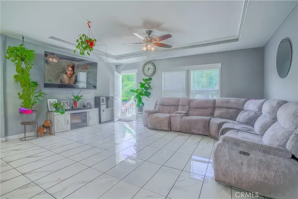 a living room with furniture and a chandelier