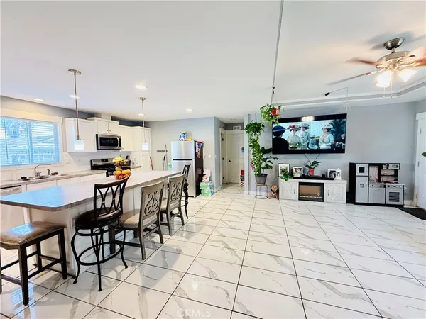 a kitchen with stainless steel appliances kitchen island granite countertop a sink and cabinets