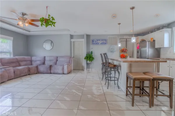 a living room with furniture and a dining table