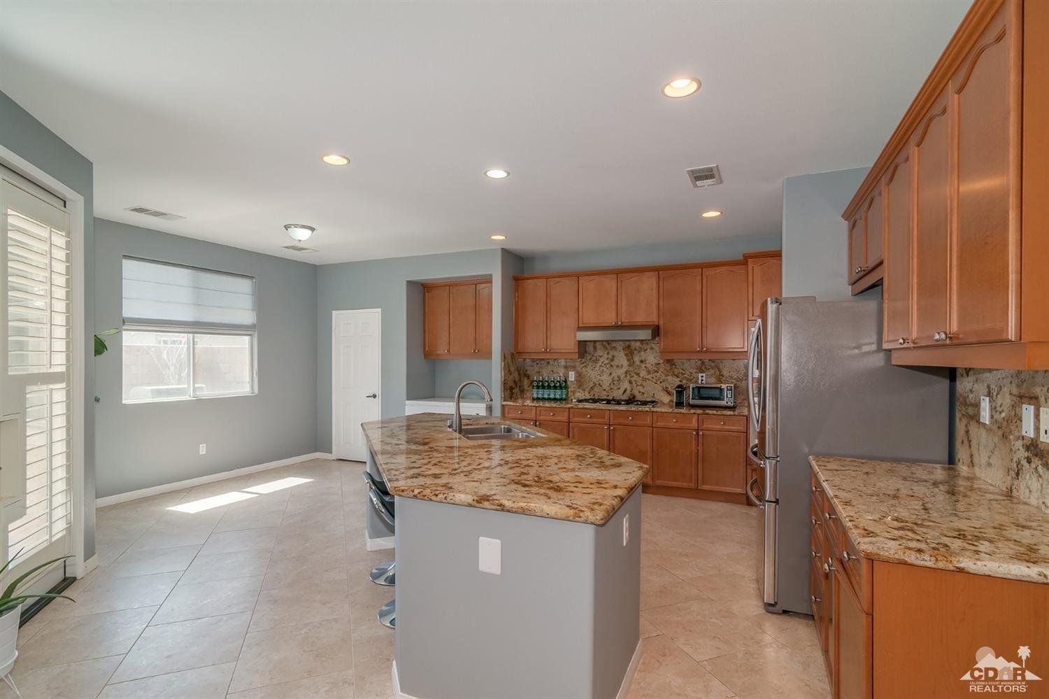 83403 Lightning Road Indio, CA 92203 - Photo 7 of 32 a kitchen with granite countertop sink and cabinets